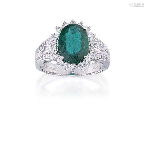 An emerald and diamond ring, the oval emerald, weighing appr...