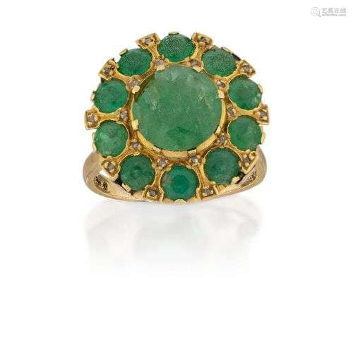 A 9ct gold and emerald cluster ring, the central collet-set ...
