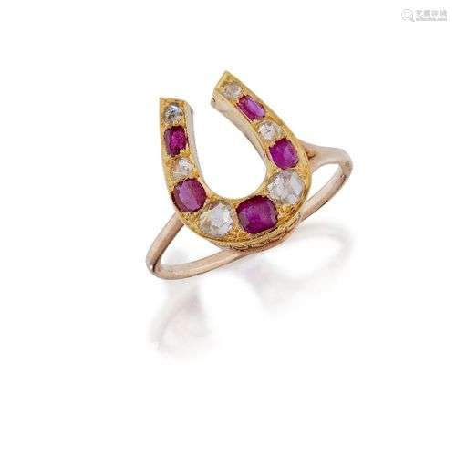A ruby and diamond horse shoe ring, the horse shoe design be...