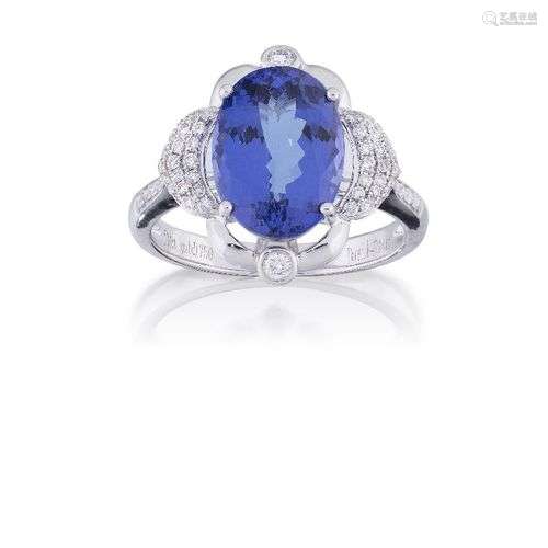 A tanzanite and diamond ring, the oval tanzanite, weighing a...