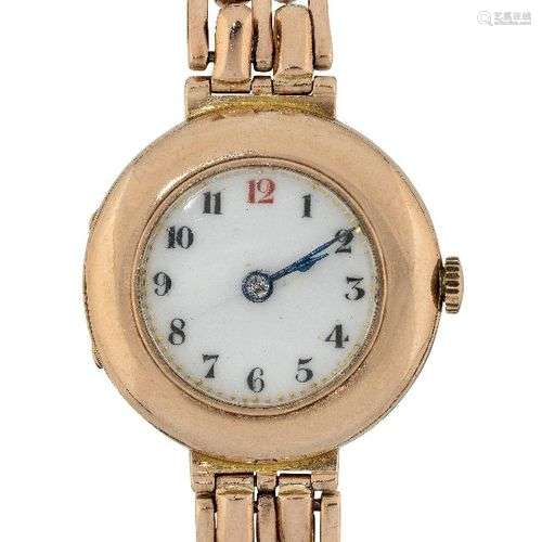 A lady's 9ct gold wristwatch, the white enamel circular dial...