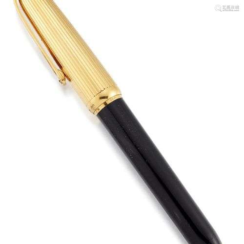 A gold plated and black lacquer fountain pen by Cartier, the...
