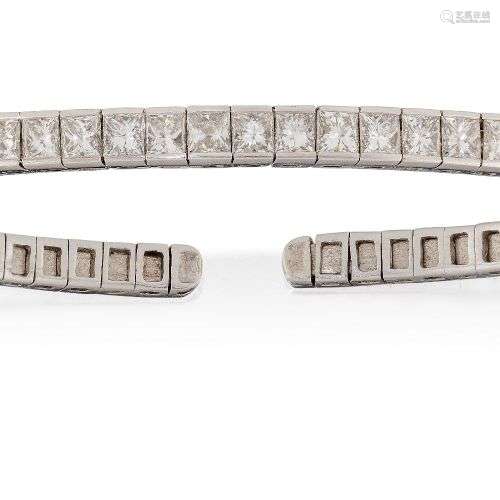 A diamond bangle, of sprung open half-hoop design, the front...