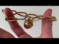 An 18k gold bracelet with a walnut charm