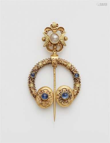 A 14k gold Celtic style fibula brooch