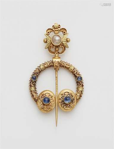 A 14k gold Celtic style fibula brooch