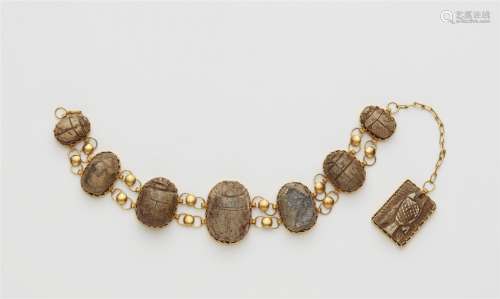 A 21k gold bracelet with scarab amulets
