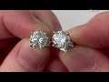 A pair of diamond solitaire earrings