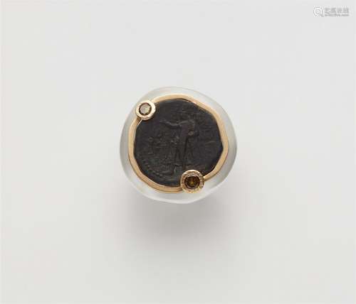 A 14k gold cocktail ring with an ancient coin