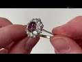 An 18k gold ruby and diamond cluster ring