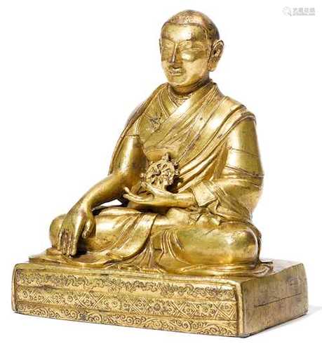 A GILT COPPER ALLOY FIGURE OF A HIGH RANKING MONK.