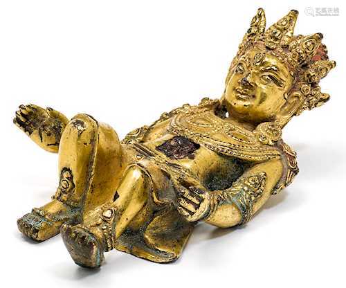 A GILT BRONZE FIGURE OF A SUBDUED GOD.