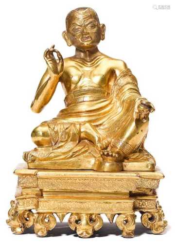 A GILT COPPER ALLOY FIGURE OF ARHAT NAGASENA.