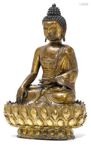 A GILT REPOUSSE FIGURE OF THE SEATED BUDDHA SHAKYAMUNI.