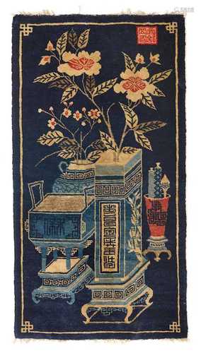 A BAOTOU CARPET DECORATED WITH VASES AND FLOWERS.