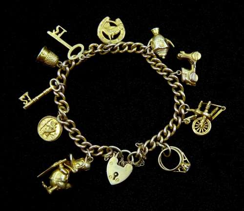 9ct gold curb chain bracelet with heart locket and ten 9ct g...
