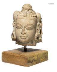 An Indian sandstone head of a female with an elaborate haird...