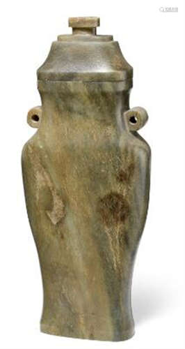 A Chinese green-brown jade vase of slender baluster shape, s...