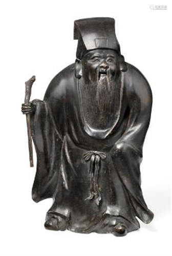 A Chinese patinated bronze figure of a Daoist Immortal. Late...