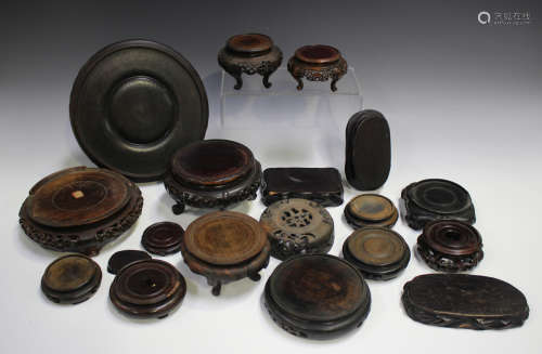 A collection of eighteen mostly Chinese wood stands, late 19...