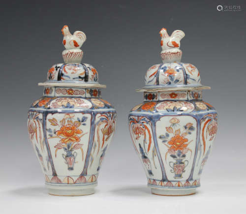 A pair of Japanese Imari porcelain jars and covers with cock...