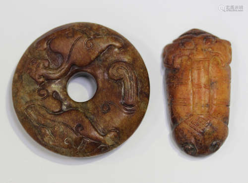 A Chinese russet jade bi pendant, carved in relief with chil...