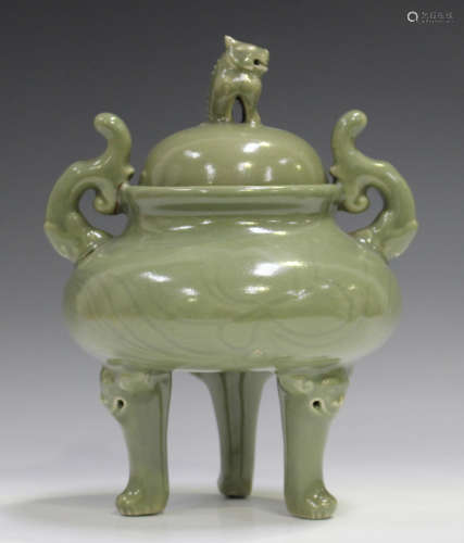 A Chinese celadon glazed tripod censer and cover with recumb...