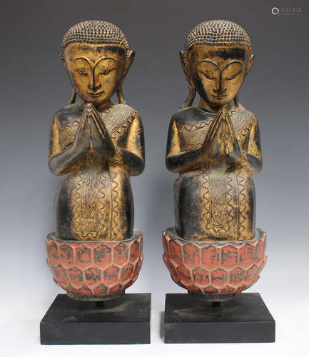 A pair of South-east Asian lacquered and carved wood figural...