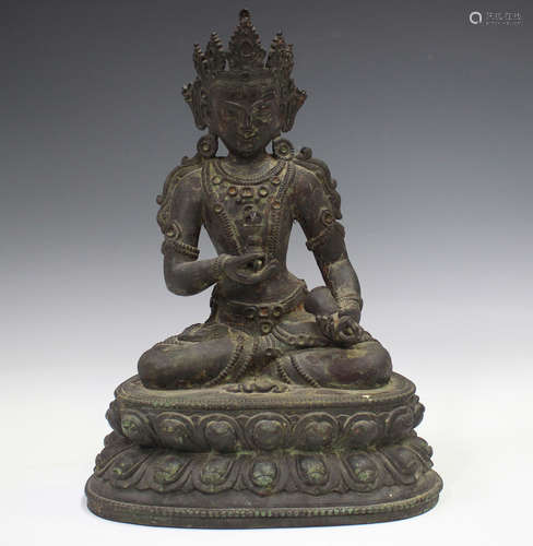 A Sino-Tibetan dark brown patinated bronze figure of Vajrapa...