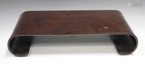 A Chinese hardwood stand, early 20th century, of scroll form...