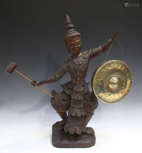 A Burmese carved hardwood figural gong stand, early 20th cen...