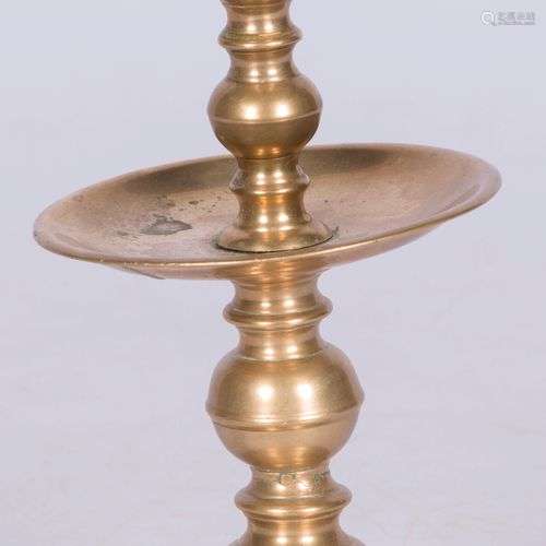 A bronze disc candle holder, late 18th century.