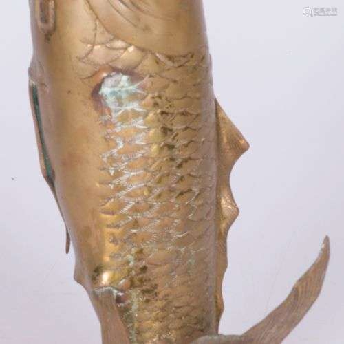 A bronze sculpture in the shape of an Arowana (fish / symbol...