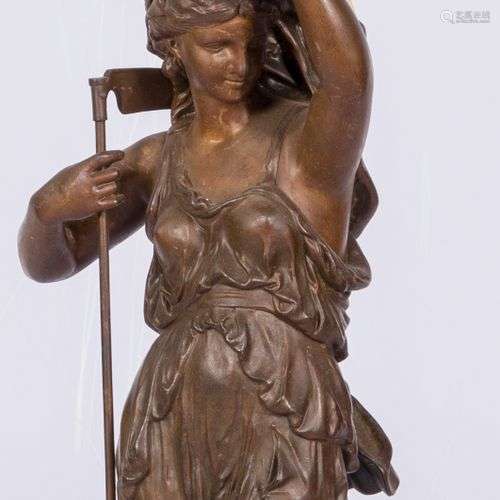 A bronze statue depicting the harvest holding a lamp, France...