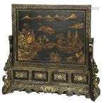 A Chinese lacquer panel with depictions of Chinese landscape...