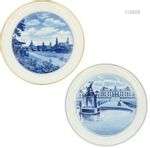 A lot with (2) porcelain plates decorated with cityscapes. M...