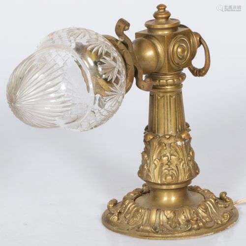 A brass wall lamp with cut glass shade, ca. 1900.