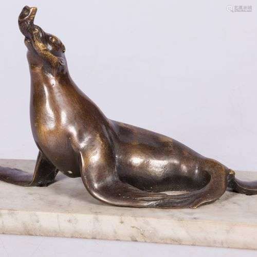 A bronze sculpture of a seal with fish in its beak, France, ...