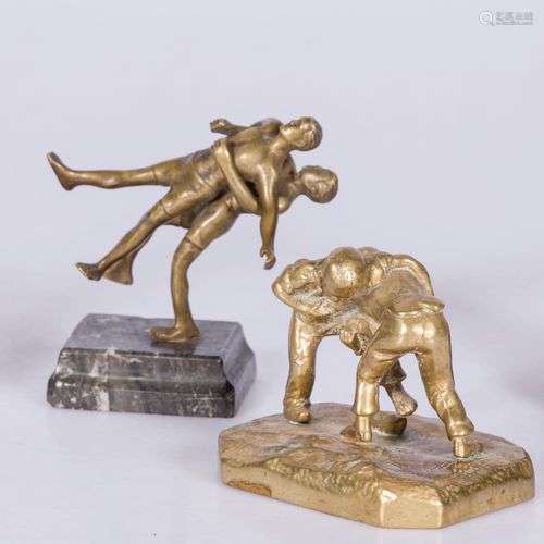 A lot of (4) various bronze sculptures, including of wrestle...