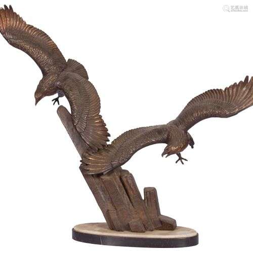 A ZAMAC sculpture of two bald eagles landing on a rock forma...