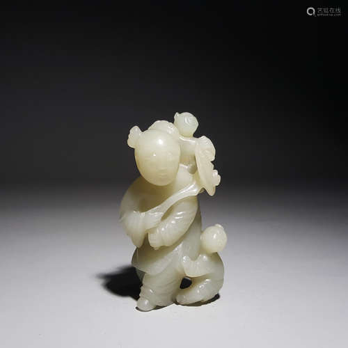 A Carved Hetian Jade Boy Holding Ruyi Ornament