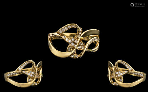 18kt Gold Ladies Ring with a ribbon design set with small di...