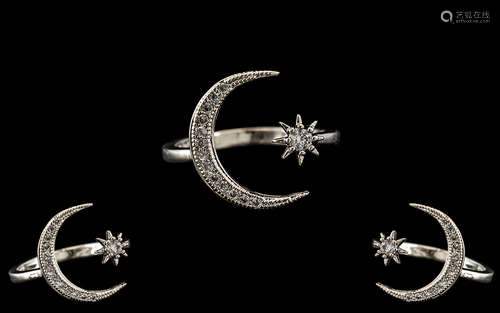 A Silver Fashion Ring form of a crescent set with white face...