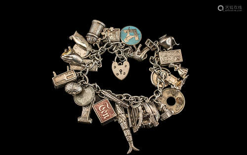 A Vintage Sterling Silver Charm Bracelet - Loaded with 25 Si...