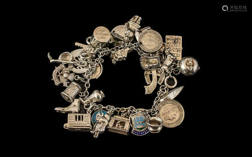 A Vintage Sterling Silver Charm Bracelet Loaded with over 25...