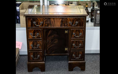 A Modern Mahogany Kneehole Desk, long frieze drawer above tw...