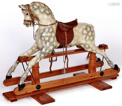 A painted wood rocking horse, mid 20th c, with leather saddl...