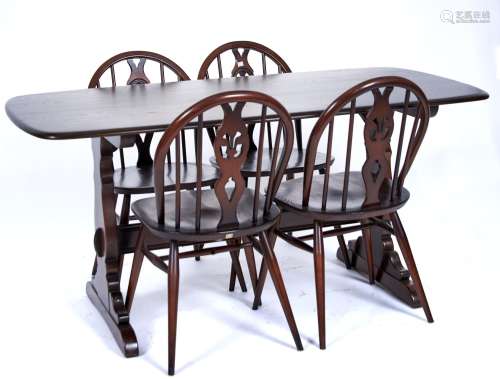 An Ercol elm dining table and set of four chairs, modern, th...