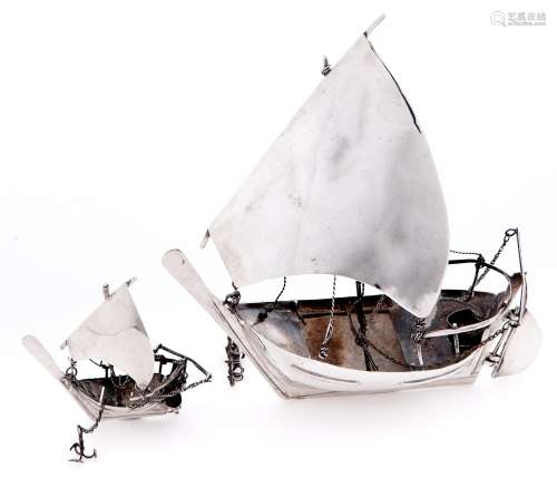 A South East Asian silver model of a boat and a similar smal...