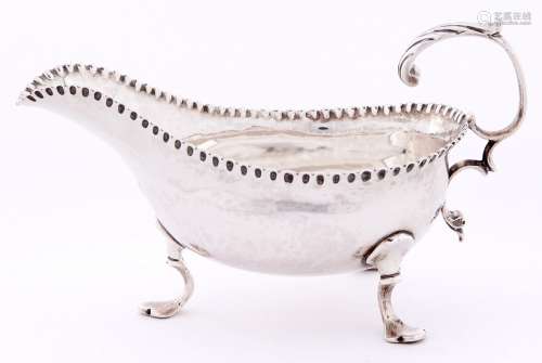 A George III silver sauce boat, with leaf capped flying scro...